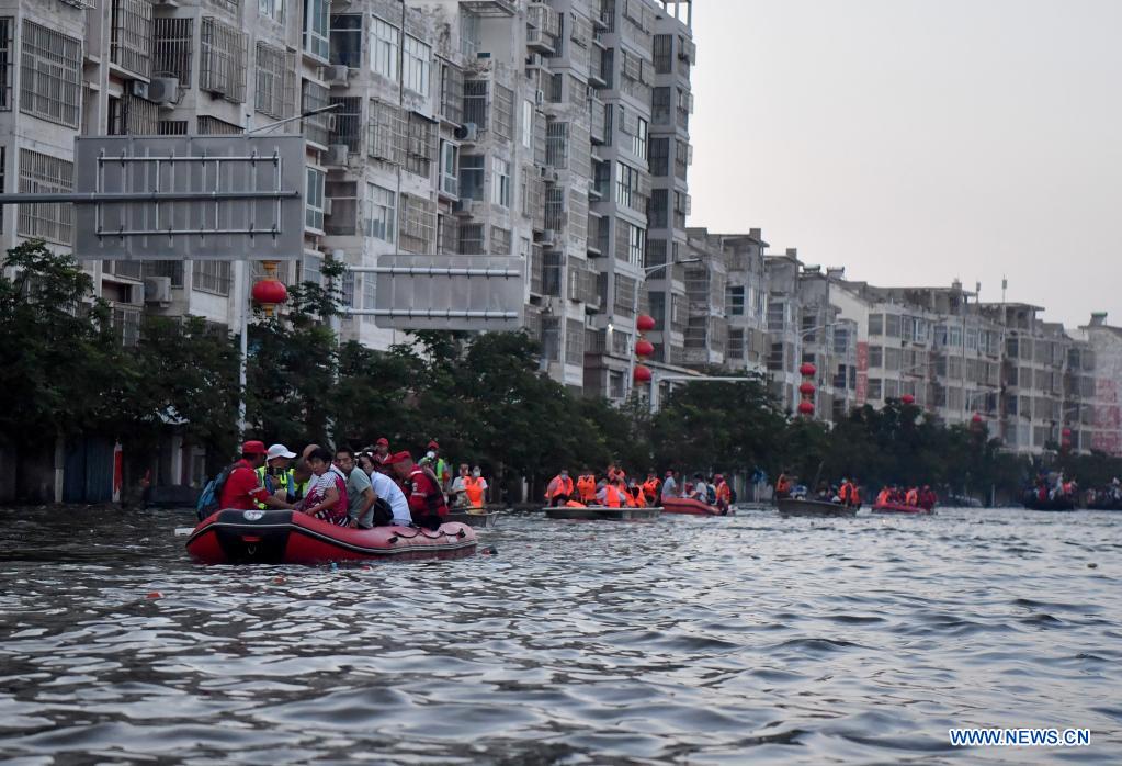 Stranded residents are transferred to safe areas aboard rescue boats in Weihui, Xinxiang City of central China's Henan Province, July 26, 2021. Weihui is suffering from serious flooding caused by heavy downpour in the past few days. Rescue work is still in progress there. (Xinhua/Li Jianan)