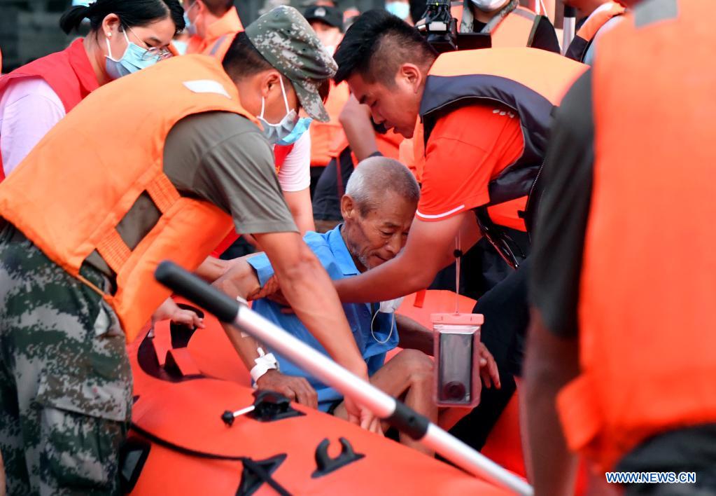 Rescuers transfer a patient to safe areas at a hospital in Weihui, Xinxiang City of central China's Henan Province, July 26, 2021. Weihui is suffering from serious flooding caused by heavy downpour in the past few days. Rescue work is still in progress there. (Xinhua/Li Jianan)