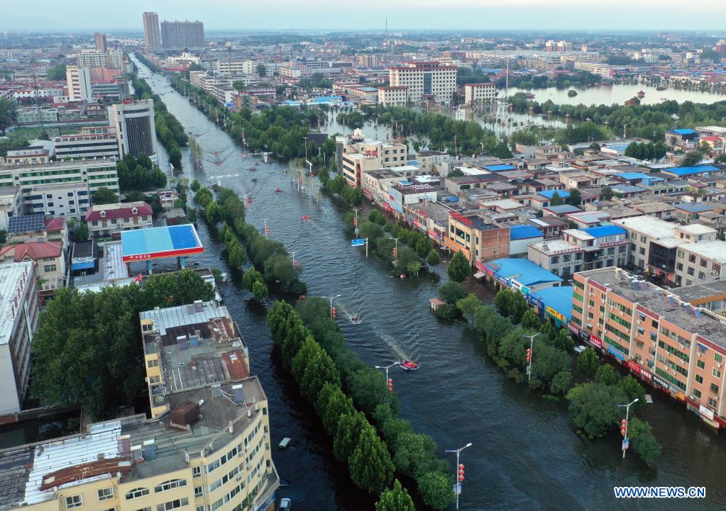 Aerial photo taken on July 26, 2021 shows rescue boats operating on waterlogged streets in downtown Weihui, Xinxiang City of central China's Henan Province. Weihui is suffering from serious flooding caused by heavy downpour in the past few days. Rescue work is still in progress there. (Xinhua/Li Jianan)