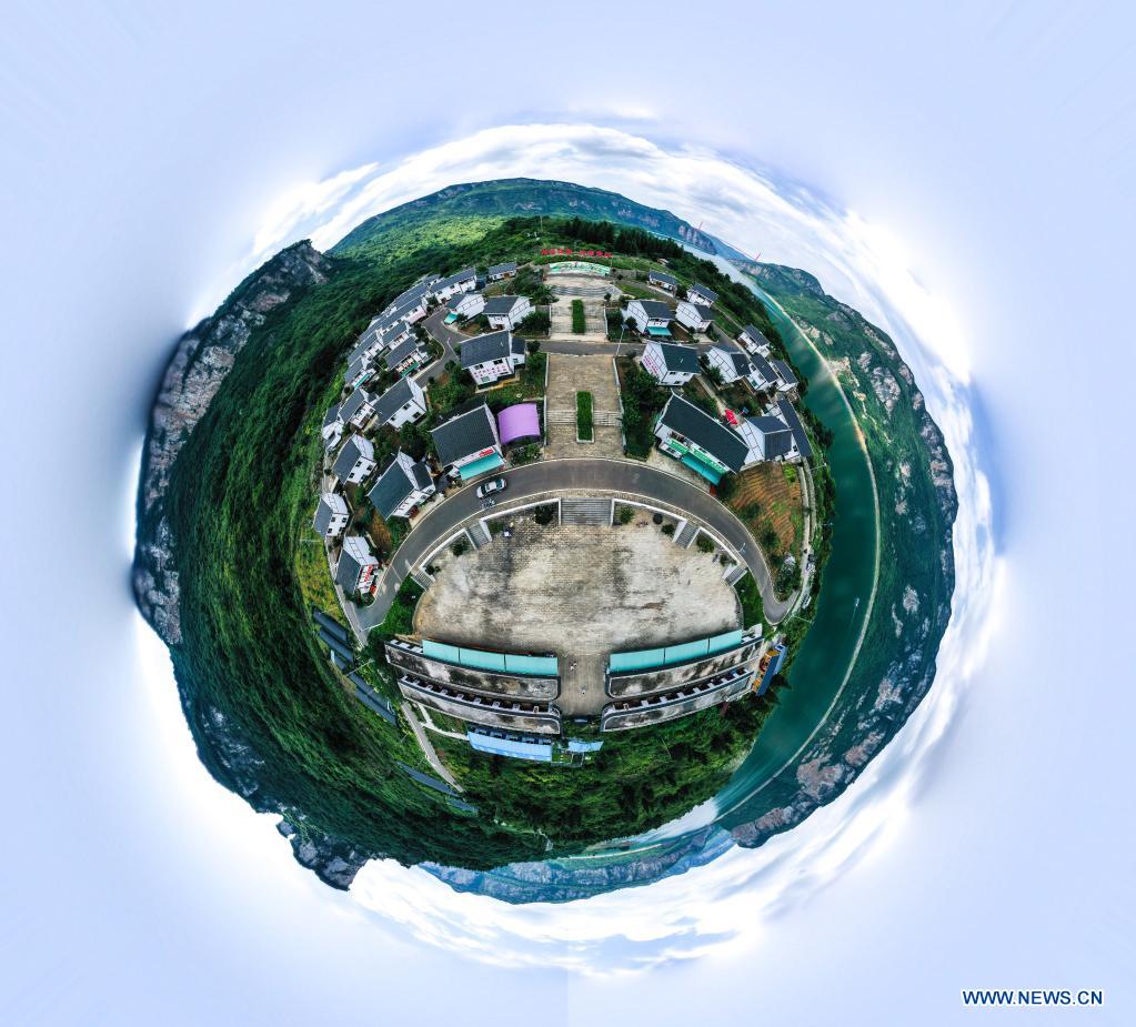 Aerial panorama photo taken on July 24, 2021 shows a view of a relocation site for poverty alleviation at Huawu Village in Xinren Miao Township, Qianxi City, southwest China's Guizhou Province. Huawu Village, although boasting unique ethnic Miao culture and splendid mountain views with vast water bodies, once had a poverty headcount ratio as high as 63.6 percent. Taking advantage of the rich cultural and natural heritage, the local government initiated a scenic area project as a targeted measure to shake off poverty to boost tourism by constructing a 