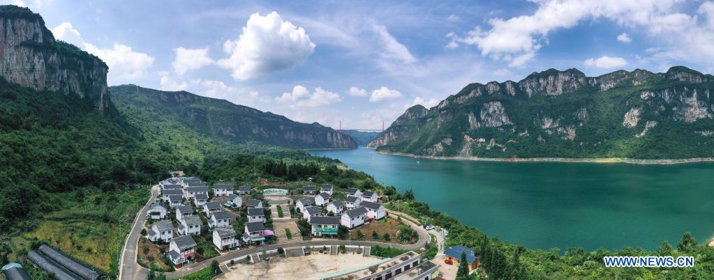 Aerial panorama photo taken on July 24, 2021 shows a view of a relocation site for poverty alleviation at Huawu Village in Xinren Miao Township, Qianxi City, southwest China's Guizhou Province. Huawu Village, although boasting unique ethnic Miao culture and splendid mountain views with vast water bodies, once had a poverty headcount ratio as high as 63.6 percent. Taking advantage of the rich cultural and natural heritage, the local government initiated a scenic area project as a targeted measure to shake off poverty to boost tourism by constructing a 