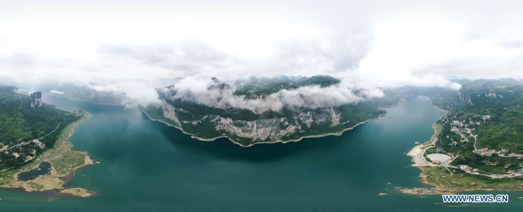 Aerial panorama photo taken on July 24, 2021 shows an early morning view of Huawu Village in Xinren Miao Township, Qianxi City, southwest China's Guizhou Province. Huawu Village, although boasting unique ethnic Miao culture and splendid mountain views with vast water bodies, once had a poverty headcount ratio as high as 63.6 percent. Taking advantage of the rich cultural and natural heritage, the local government initiated a scenic area project as a targeted measure to shake off poverty to boost tourism by constructing a 