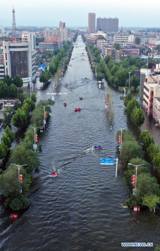 Aerial photo taken on July 26, 2021 shows rescue boats operating on waterlogged streets in downtown Weihui, Xinxiang City of central China's Henan Province. Weihui is suffering from serious flooding caused by heavy downpour in the past few days. Rescue work is still in progress there. (Xinhua/Li Jianan)