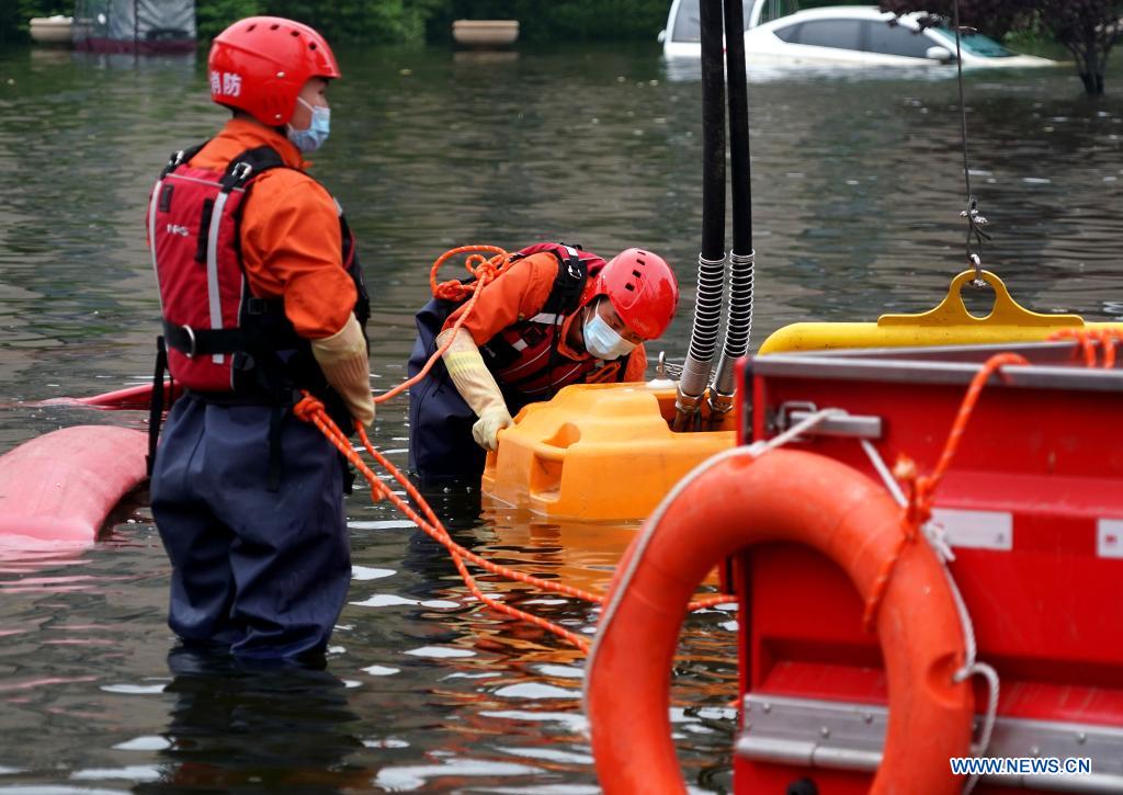 Rescuers operate a pump to drain rainwater out of a road in flood-hit Weihui City, central China's Henan Province, July 28, 2021. Weihui City suffered from severe urban waterlogging due to the extremely heavy rainfall. Rescue and drainage work is still in progress there. (Xinhua/Li An)