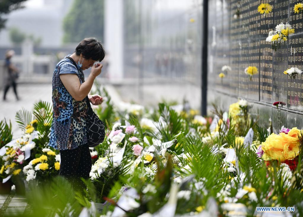 A woman mourns in front of a memorial wall at the Tangshan Earthquake Memorial Park in Tangshan, north China's Hebei Province, July 28, 2021. Wednesday marks the 45th anniversary of the Tangshan earthquake. The 7.8-magnitude quake struck the city of Tangshan in Hebei Province on July 28, 1976, killing more than 240,000 people and destroying virtually all buildings. (Photo by Zhao Liang/Xinhua)