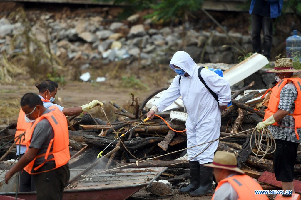 Staff members conduct disinfection in flood-hit Qixian County of Hebi City, central China's Henan Province, July 28, 2021. Several parts of Qixian County are suffering from flooding caused by heavy downpour in the past few days. (Xinhua/Li Jianan)