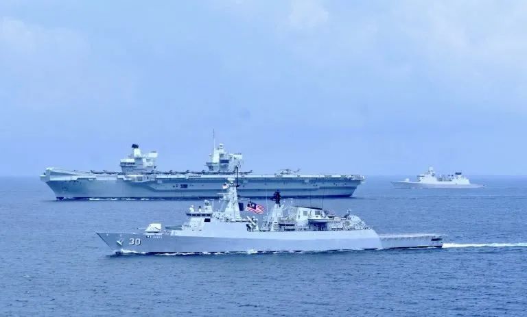 ▲7月25日，马来西亚海军护卫舰护送“女王”号航母通过马六甲海峡。（英国国防部网站）