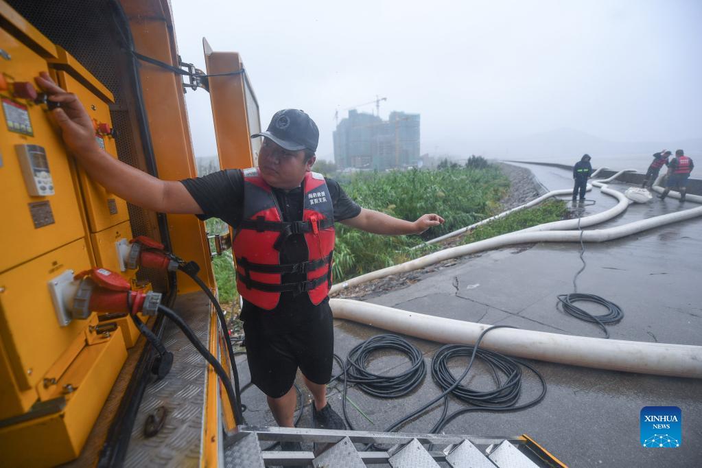 Rescuers pump rainwater out of a pool in Zhoushan, east China's Zhejiang Province, Sept. 13, 2021. Zhejiang Province has upgraded its emergency response to Typhoon Chanthu to the highest level, closing schools as well as suspending air and rail services in several cities. (Xinhua/Xu Yu)