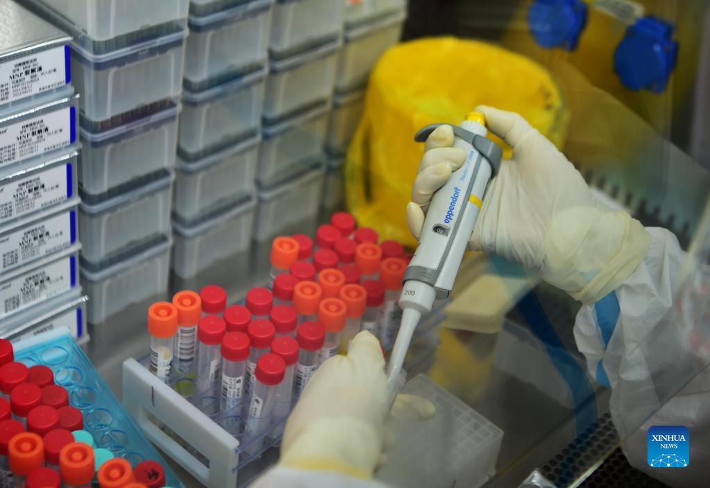 A staff member deals with nucleic acid testing samples in a PCR (polymerase chain reaction) lab in Xianyou County, southeast China's Fujian Province, Sept. 14, 2021. Three PCR labs have been built in the county to boost nucleic acid detection capacity. (Xinhua/Wei Peiquan)