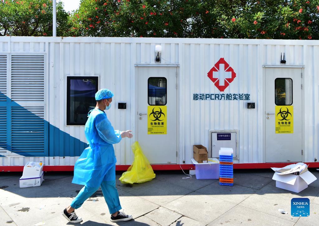 A staff member walks past a PCR (polymerase chain reaction) lab for nucleic acid testing in Xianyou County, southeast China's Fujian Province, Sept. 14, 2021. Three PCR labs have been built in the county to boost nucleic acid detection capacity. (Xinhua/Wei Peiquan)