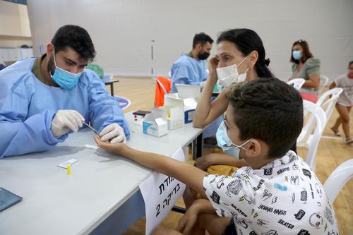 以色列开始为3岁至12岁儿童做新冠血清抗体检测，以了解未接种疫苗但对新冠病毒已有免疫力的孩子情况。图为在以色列里雄莱锡安，一名儿童接受新冠血清抗体检测。新华社/基尼图片社