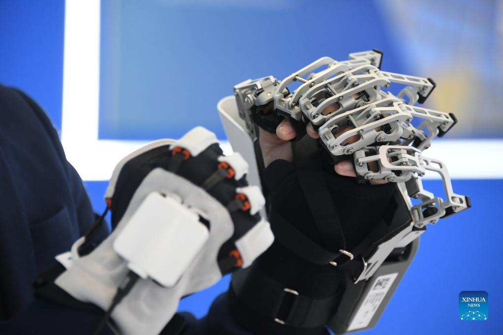 An exoskeleton for hand rehabilitation is displayed at an exhibition to mark the 2021 National Mass Innovation and Entrepreneurship Week in Beijing, capital of China, Oct. 19, 2021. The 2021 National Mass Innovation and Entrepreneurship Week was opened on Tuesday. (Xinhua/Ren Chao)