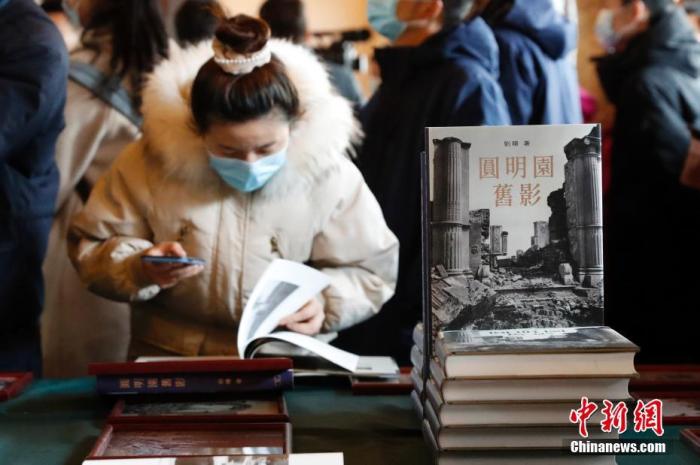 资料图:观众赏识圆明园老照片册本。 中新社记者 韩海丹 摄