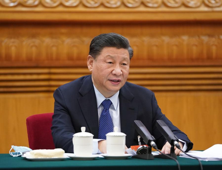 Chinese President Xi Jinping, also general secretary of the Communist Party of China Central Committee and chairman of the Central Military Commission, takes part in a deliberation with lawmakers from Qinghai Province, at the fourth session of the 13th National People&#39;s Congress in Beijing, capital of China, March 7, 2021. (Xinhua/Li Xueren)