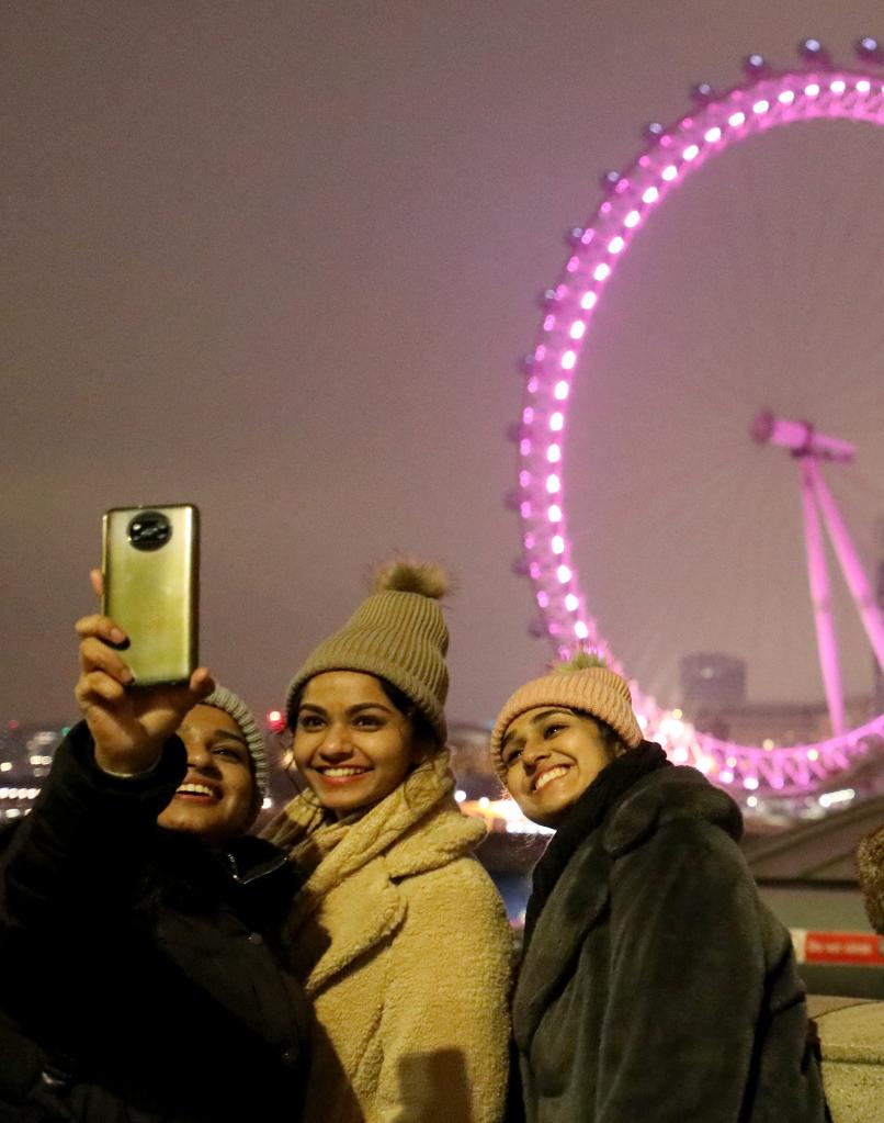 2022年1月1日，人们在英国伦敦的“伦敦眼”附近迎接新年。（新华社记者李颖摄）