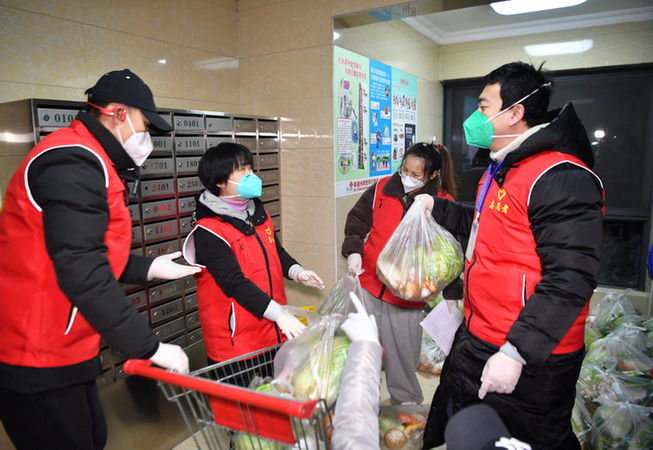  ↑2021年12月31日，西安曲江风景线小区，志愿者分拣免费生活物资。