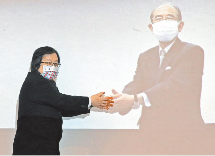 邱义仁（左）在台北会场与大桥光夫（右）“隔空握手”。图自台媒