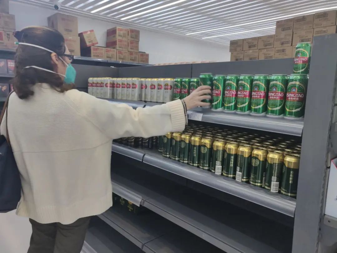 一位外国记者在媒体中心的超市选购青啤