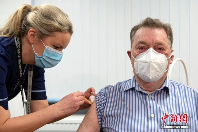资料图：在英国苏格兰邓迪的洛基健康中心，护士为一名82岁的老人注射新冠疫苗。