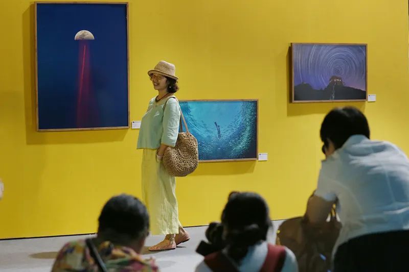 观众在“无主题艺术类”展墙前与作品合影。张双双 摄