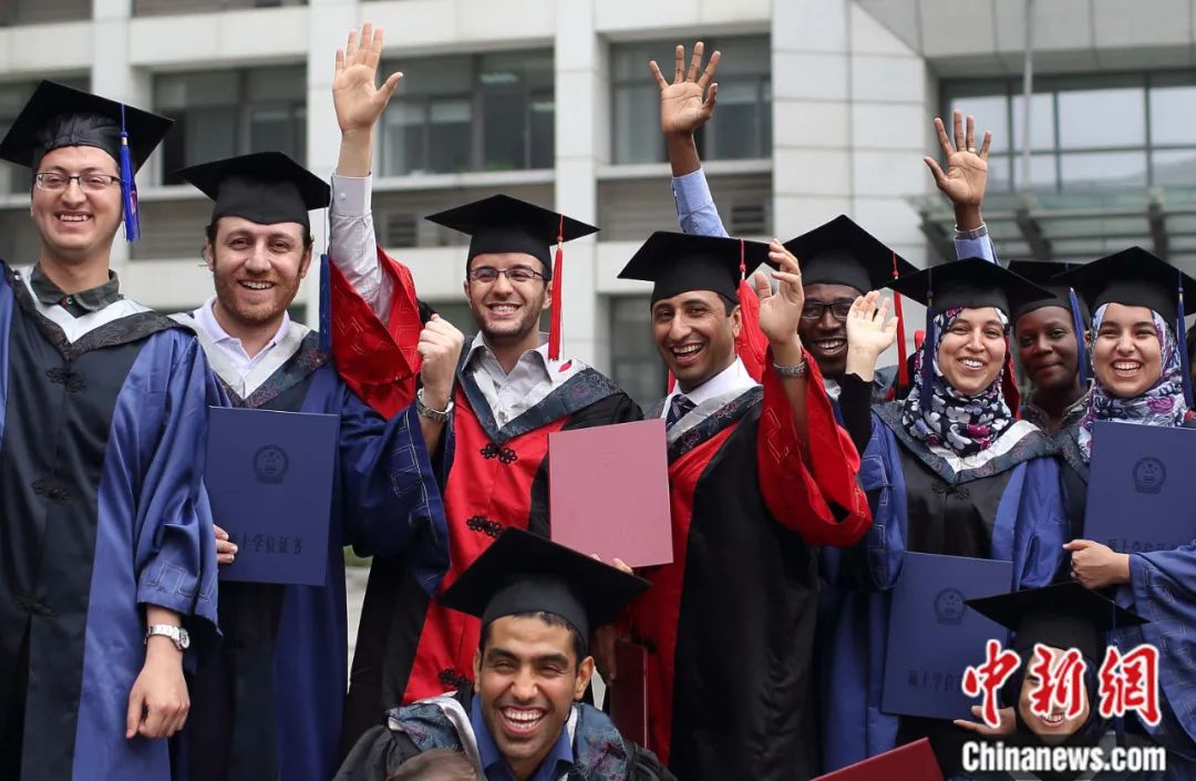 中国药科大学2014年毕业典礼上,非洲留学生手持毕业证书、身着学位服拍摄合影。中新社记者 泱波 摄