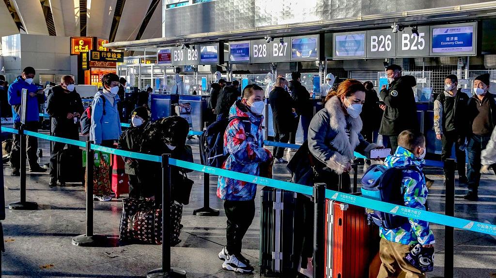 2022年12月11日，旅客在乌鲁木齐国际机场T3航站楼排队办理值机手续。视觉中国 图