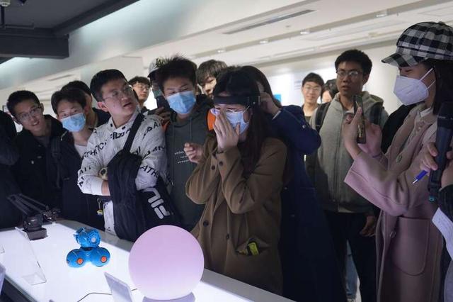现场学生在指导下体验新科技。 谷晓涵/摄