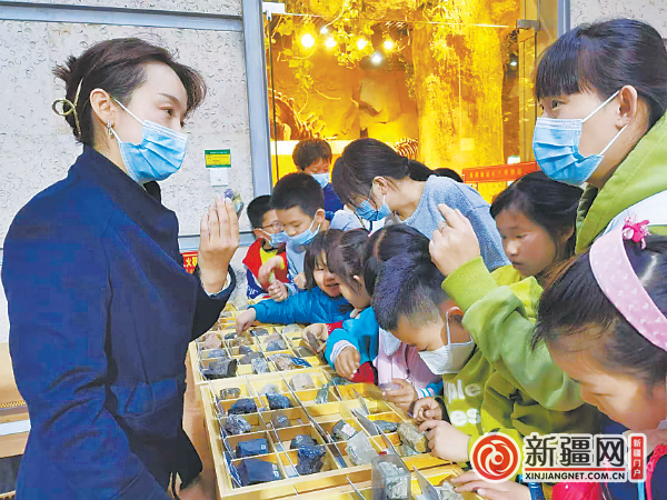 讲解员李姝逸正在给观众讲解不同的矿物标本特性。(全媒体记者江斌伟摄)