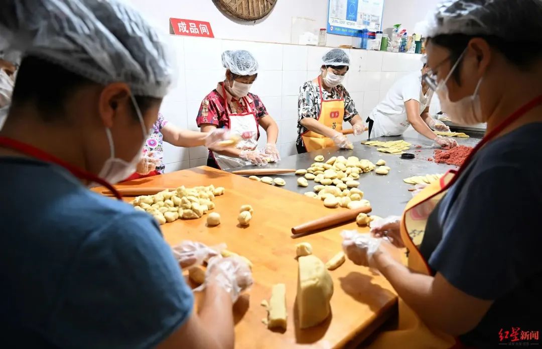▲工作人员正在手工制作老式月饼