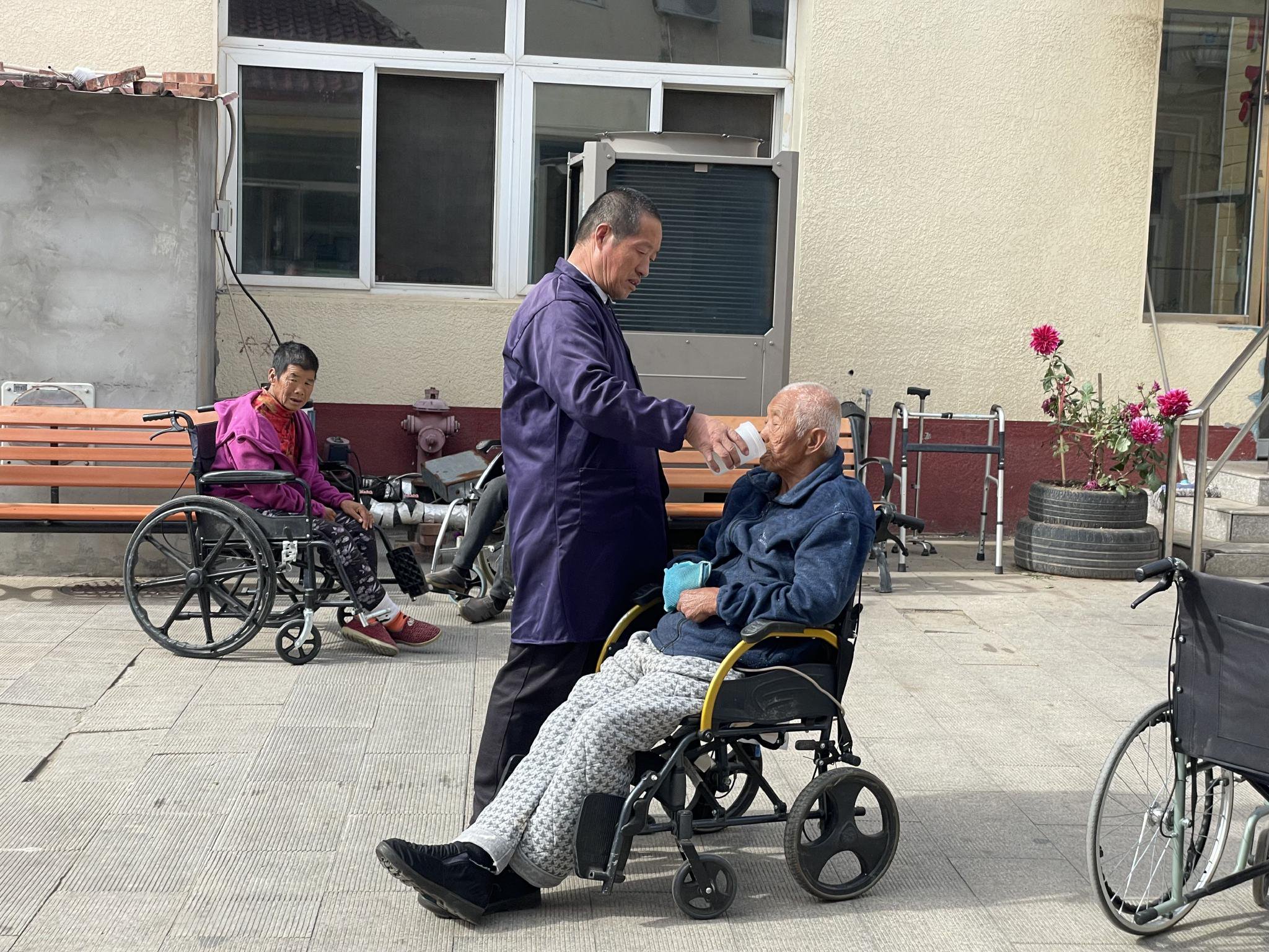 鄭寶平在喂老人喝水。新京報記者 趙利新 攝