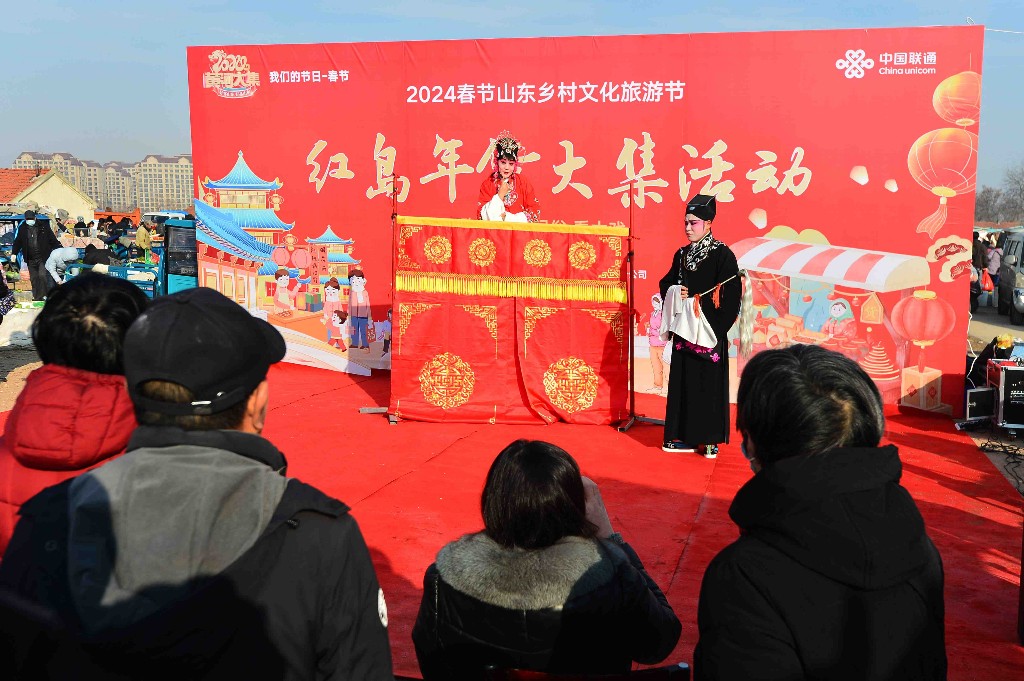 1月27日,在青岛市城阳区红岛年货节活动上,市民在大集上欣赏传统戏曲柳腔。王海滨 摄