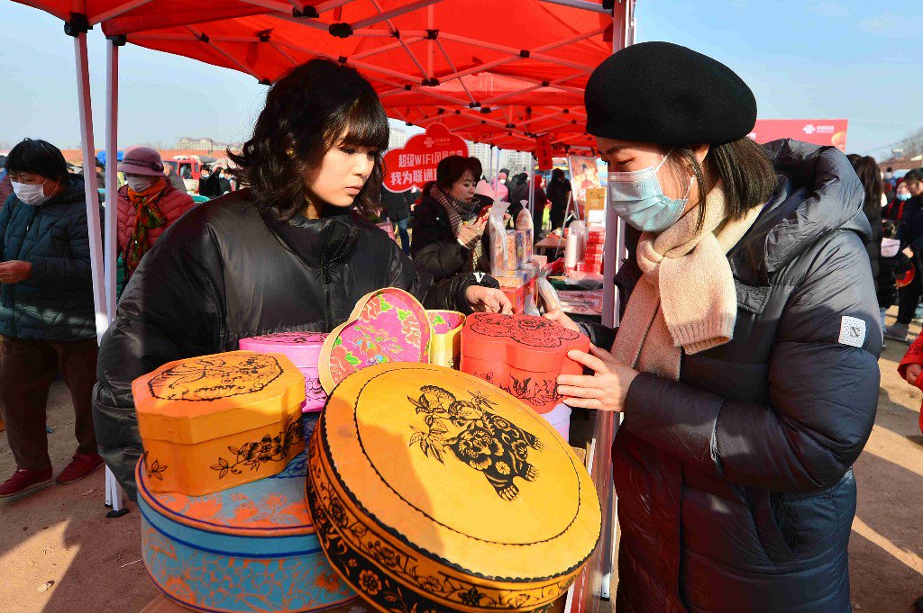 1月27日,在青岛市城阳区红岛街道举行的年货节活动上,市民在选购非遗喜盒子。王海滨 摄