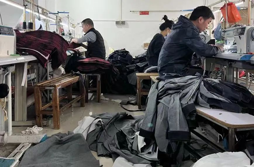 △制衣工人们在工厂做工。时代财经/摄