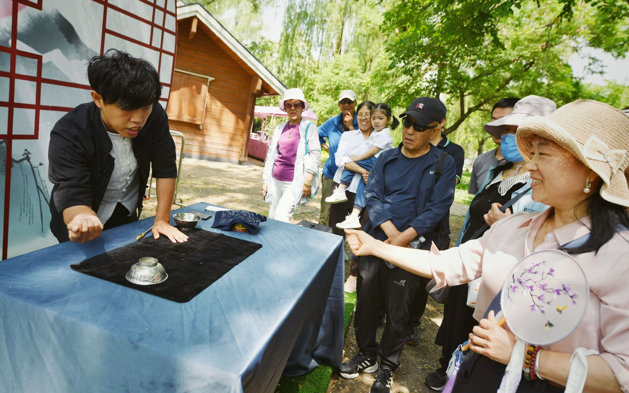 5月9日，玉淵潭公園，遊客在欣賞古彩戲法表演。新京報記者 薛珺 攝