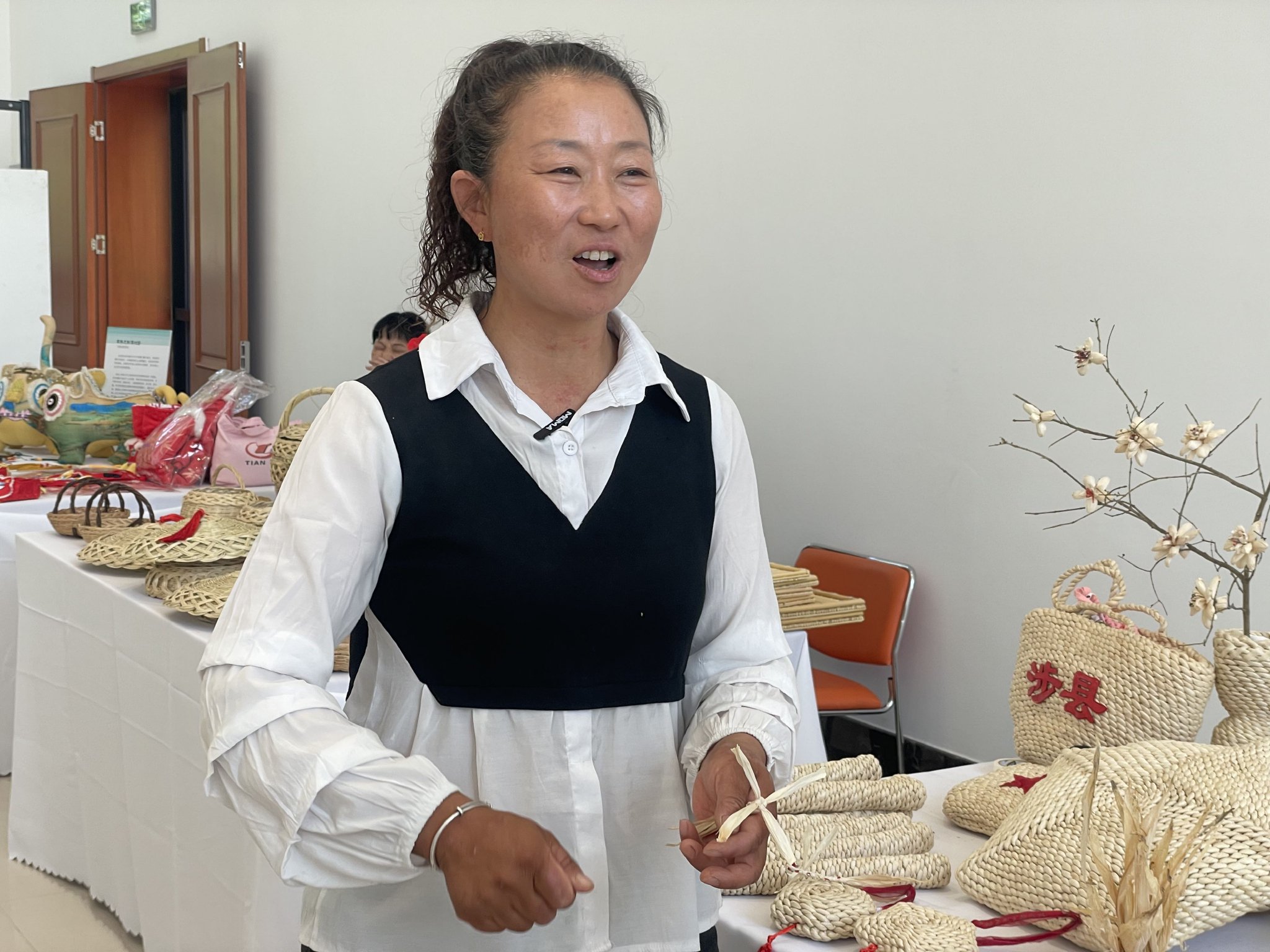 張林秀展示她用玉米皮編織的手工品。新京報記者 陳超 攝