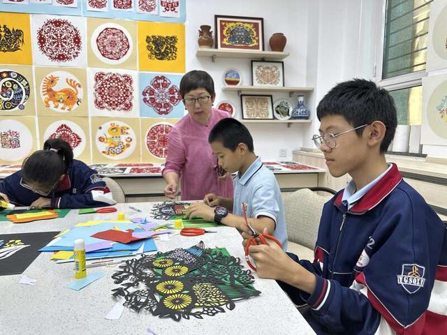 6月25日,在内蒙古自治区呼和浩特市土默特学校,一名学生学习剪纸。中青报·中青网记者 石佳/摄