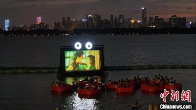 游客在东湖沙滩景区体验水上漂浮影院。 郑子颜 摄