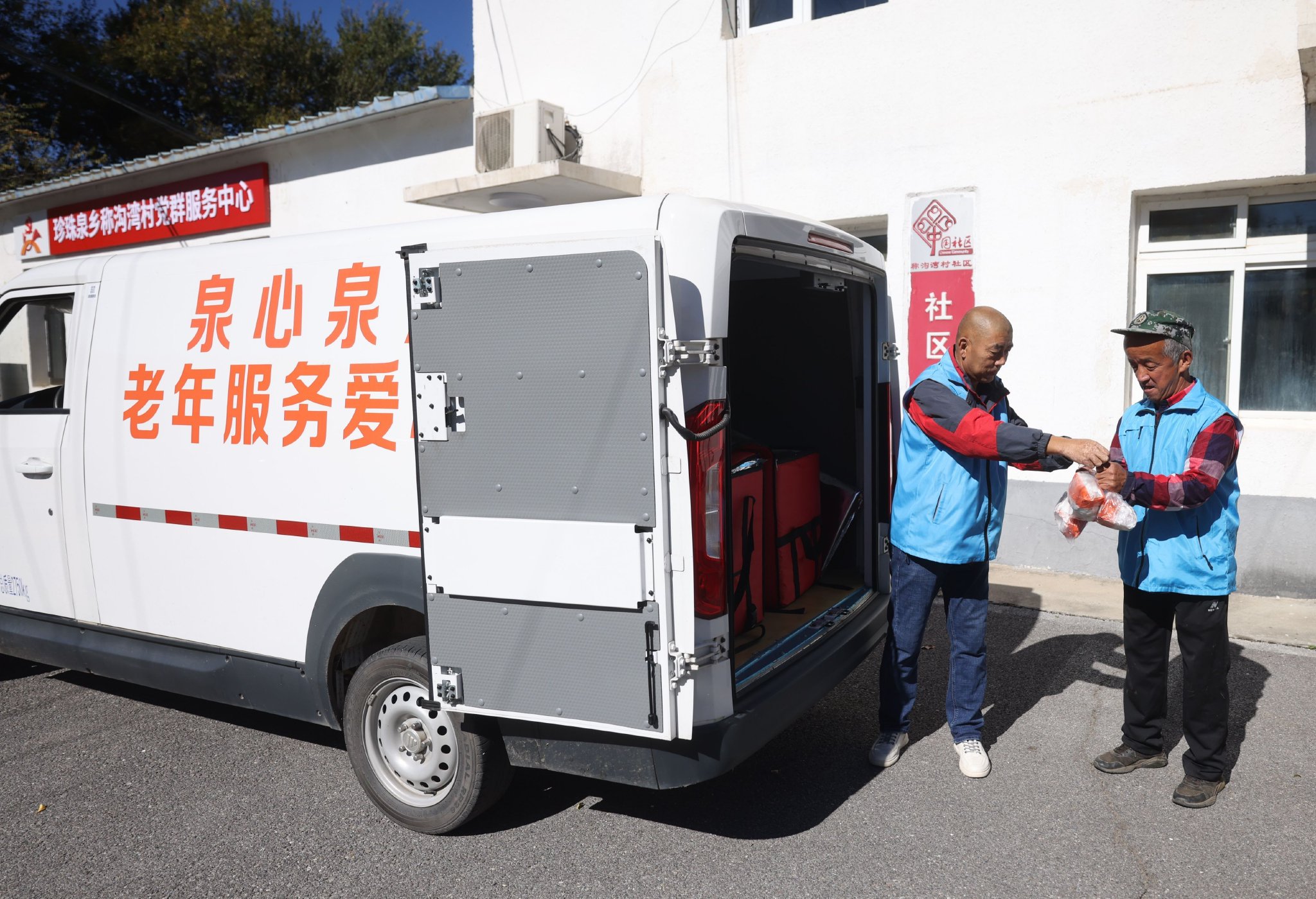 送餐車將老年餐送到稱溝灣村。新京報記者 王貴彬 攝