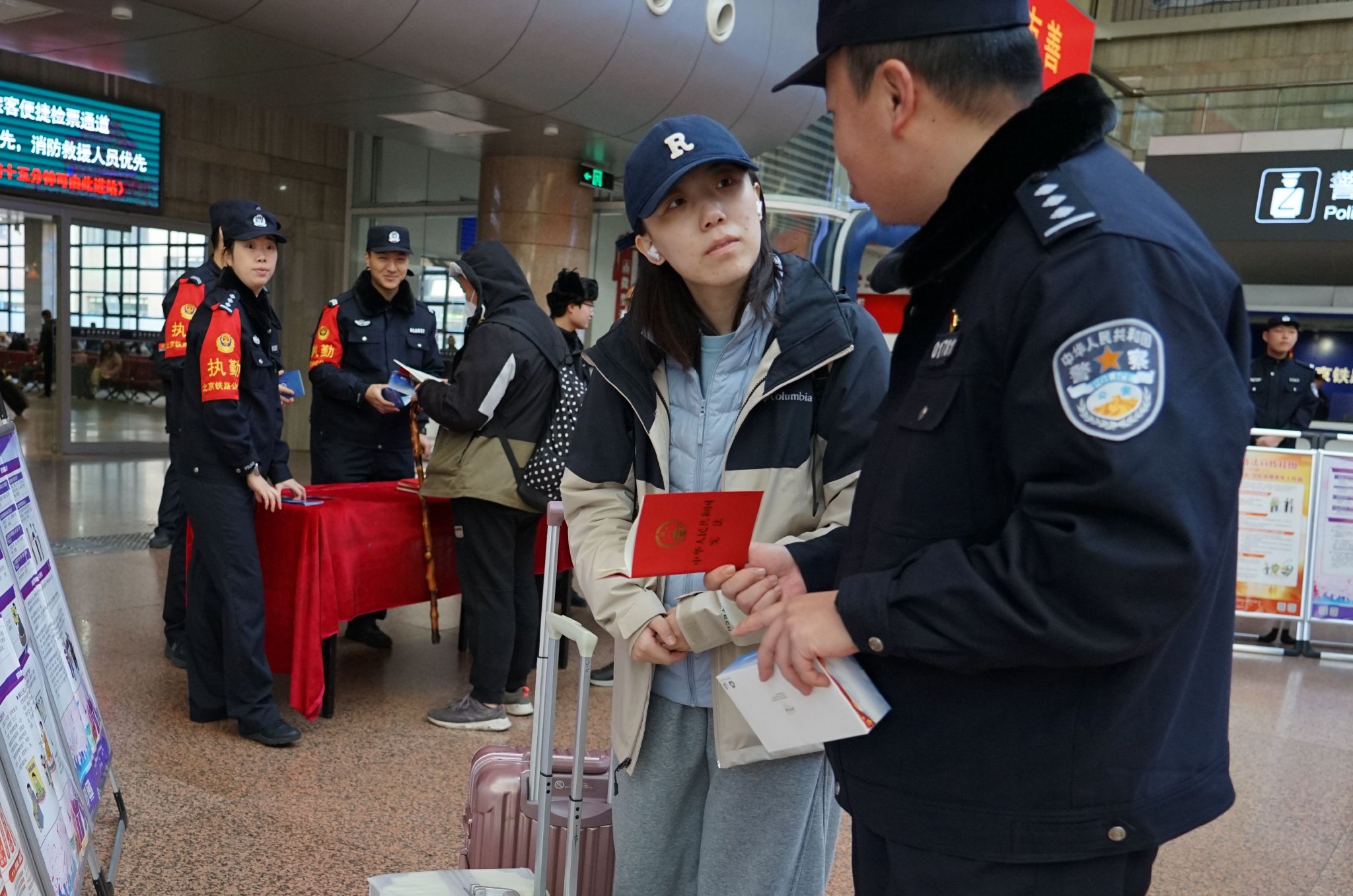 北京西站派出所民警向過往旅客發放《中華人民共和國憲法》小冊子。 圖源：北京鐵路公安處