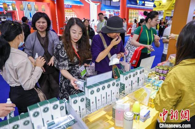 4月14日,海南海口,泰国企业展出的特色商品吸引参观者选购。中新社记者 骆云飞 摄