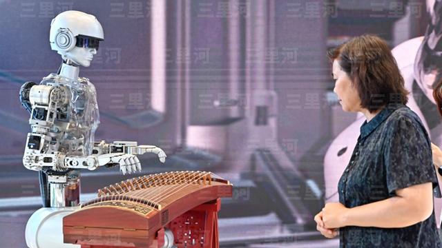 资料图:第二十一届中国(深圳)国际文化产业博览交易会上,弹“古筝”的机器人吸引参观者。图/中新社记者 陈骥旻 摄