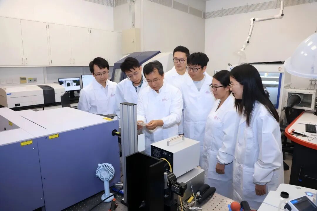 张强(左三)指导学生。图片来源:清华大学