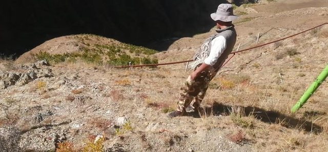 2016年，扎西曲培在南山种树的照片，图中能看到高原的高山陡坡、行路困难。受访者供图