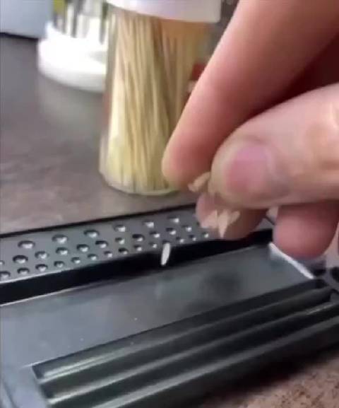 一位技艺精湛的珠宝匠将一粒米雕刻成哥斯拉雕塑