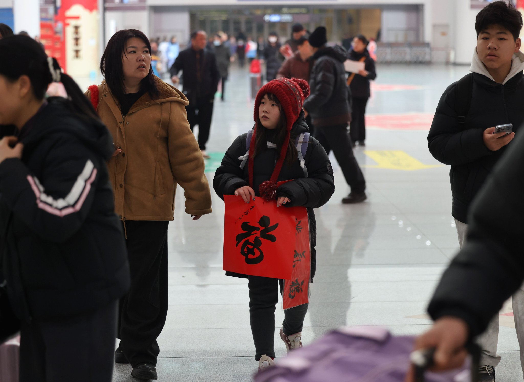 旅客拿著福字和春聯踏上回家旅程。新京報記者 王貴彬 攝