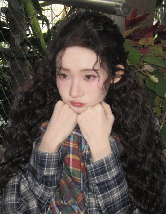 张艺凡的羊毛卷造型具体是如何修饰脸型和五官的？