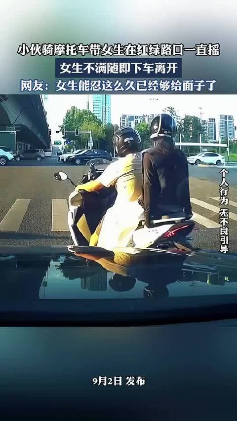 小伙骑摩托车带女生在红绿路口一直摇，女生不满随即下车离开