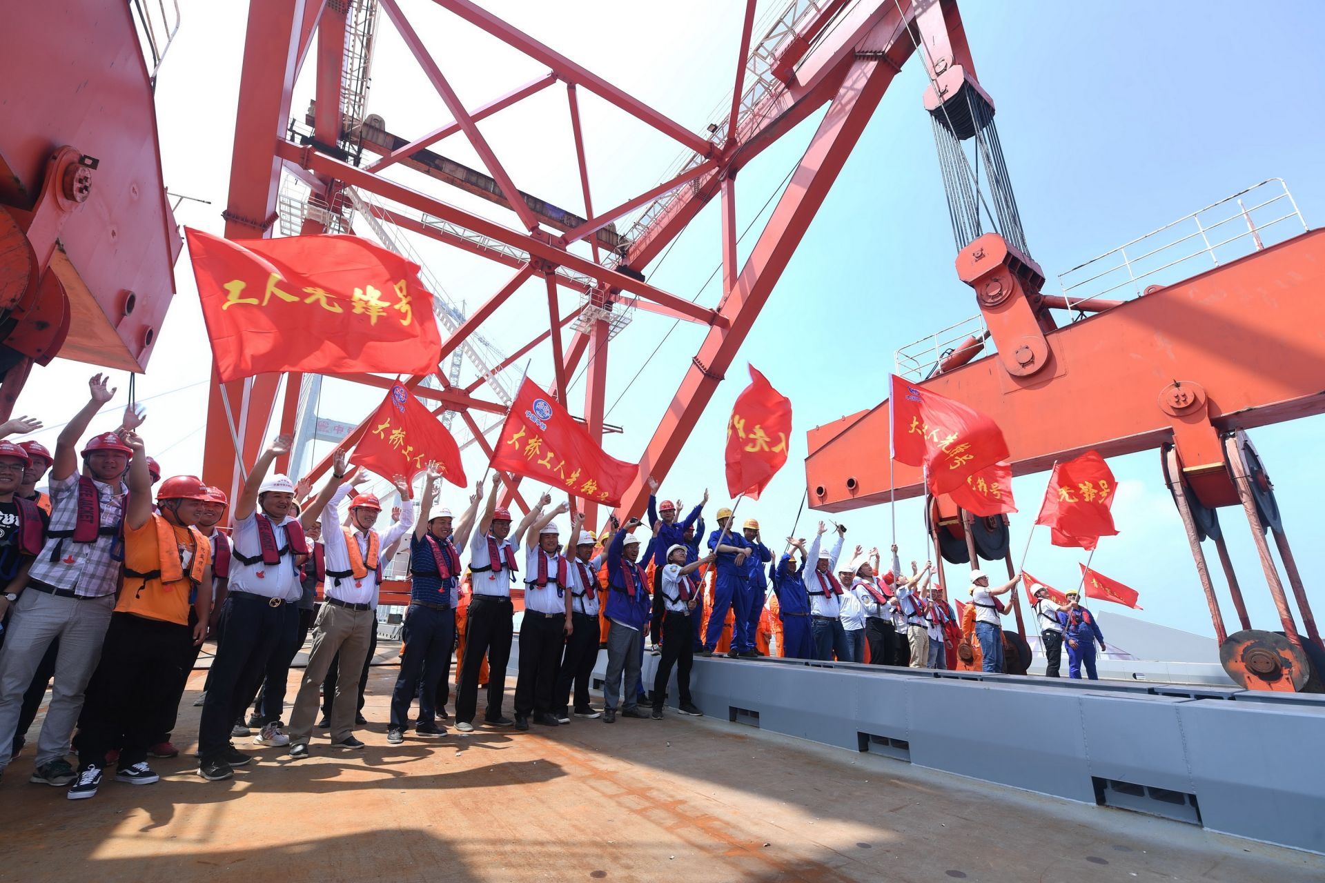 平潭海峡公铁两用大桥的工作人员庆祝元洪航道桥主桥成功合龙（新华社）