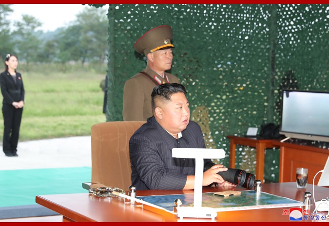 9月10日,金正恩指导超大型火箭炮试射,朴正川站在其身旁。(朝中社)