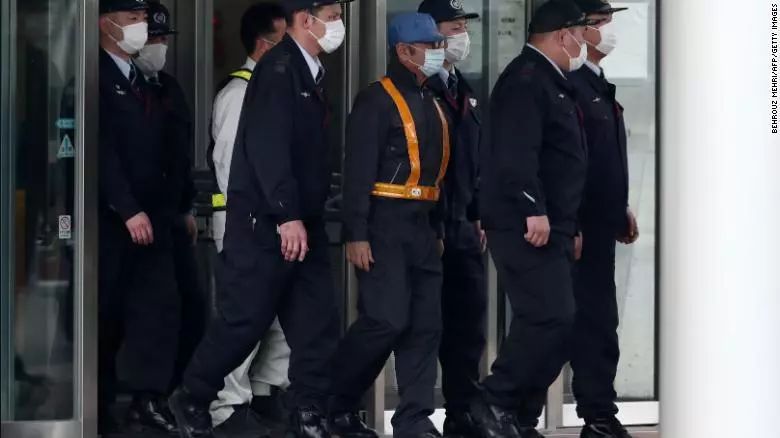 ▲戴口罩和蓝色帽子的戈恩被保释。图/CNN